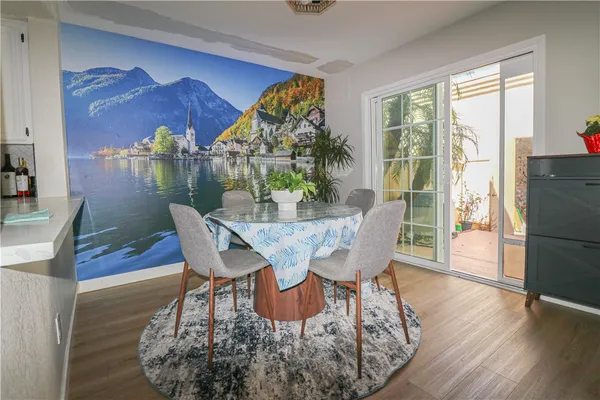a dining room with furniture a chandelier and wooden floor