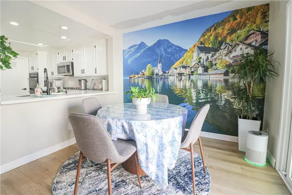 a dining room with furniture a rug and wooden floor