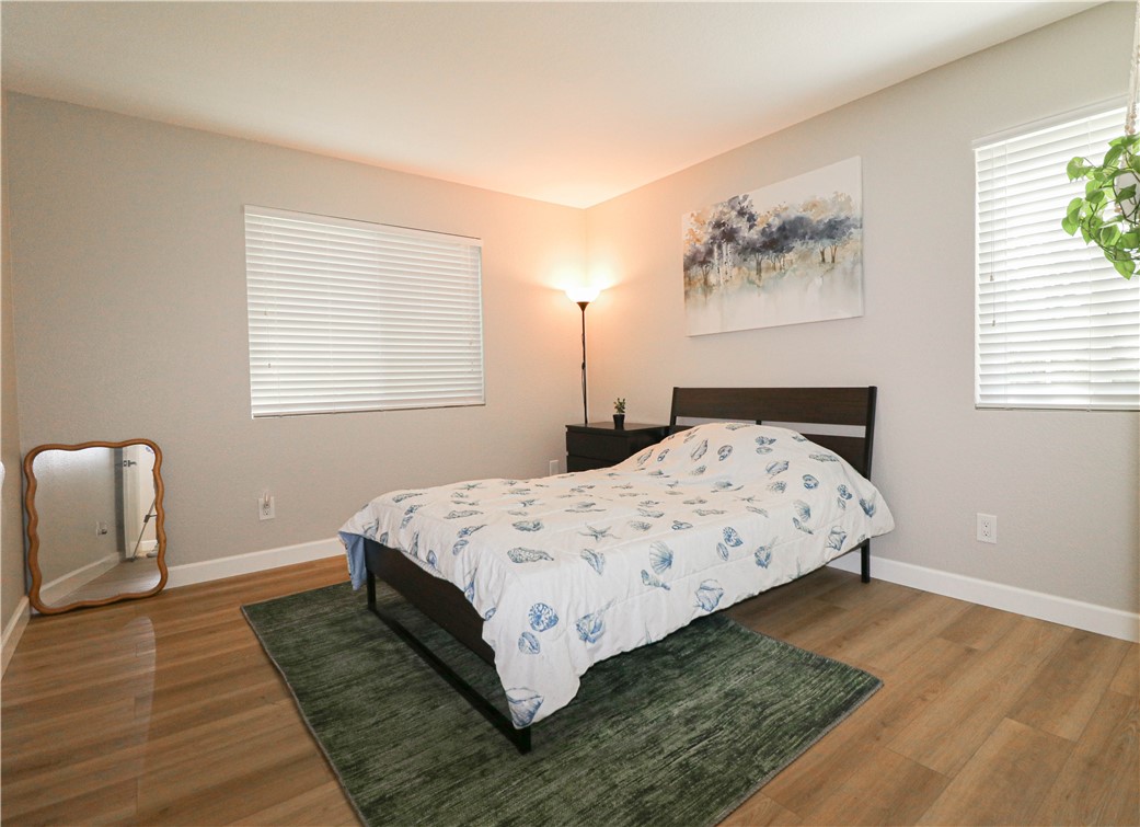 730 Breeze Hill Road, Unit 230 Vista, CA 92081 - Photo 13 of 40 a bedroom with a bed lamp on desk and a window