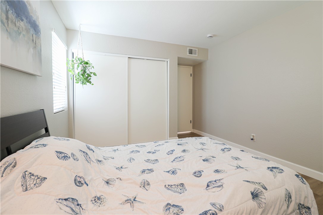 730 Breeze Hill Road, Unit 230 Vista, CA 92081 - Photo 14 of 40 a bedroom with a bed and a window