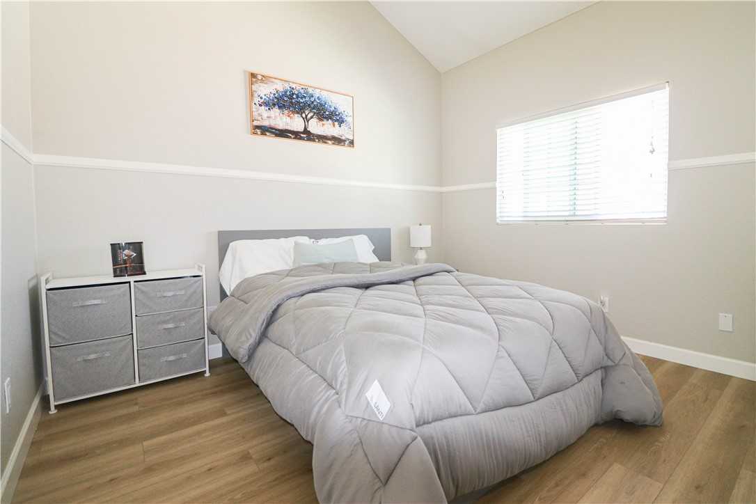 730 Breeze Hill Road, Unit 230 Vista, CA 92081 - Photo 17 of 40 a bedroom with a bed and painting on the wall