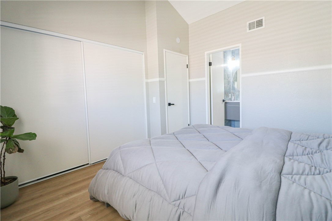 730 Breeze Hill Road, Unit 230 Vista, CA 92081 - Photo 19 of 40 a bedroom with a bed and a potted plant