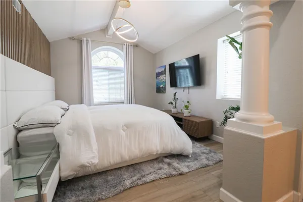 a bedroom with a bed and a flat screen tv