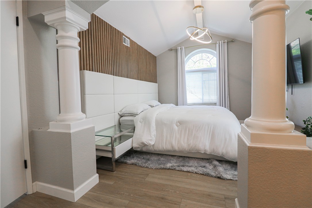 730 Breeze Hill Road, Unit 230 Vista, CA 92081 - Photo 21 of 40 a bedroom with a bed mirror and window