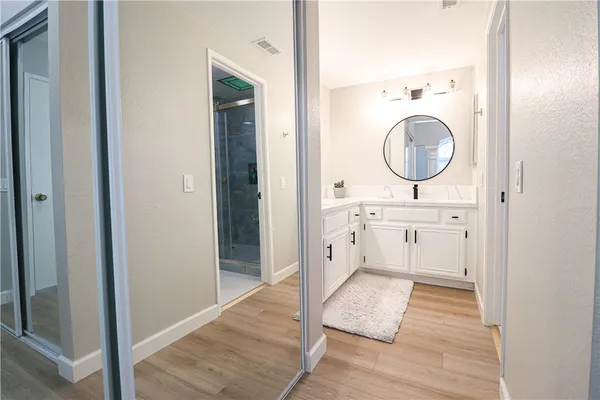 a bathroom with a sink a mirror and a shower
