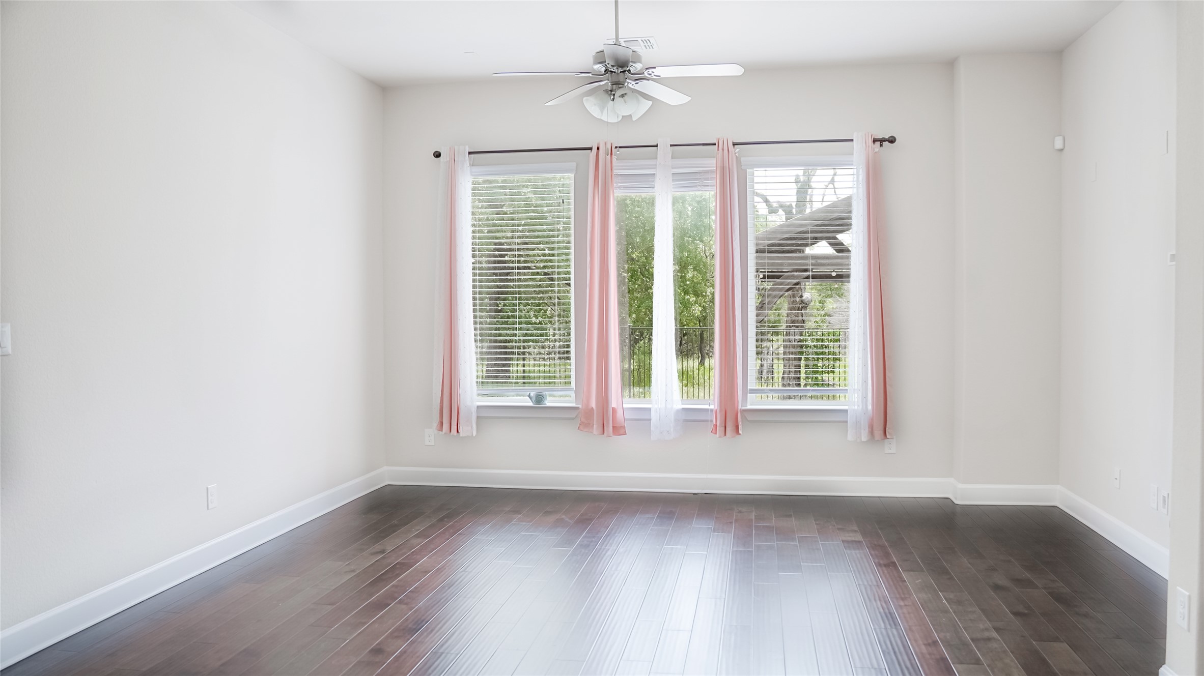 184 Fort Cobb Way Georgetown, TX 78628 - Photo 18 of 33 an empty room with wooden floor and windows