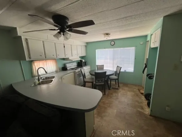 a kitchen with a table chairs and a refrigerator
