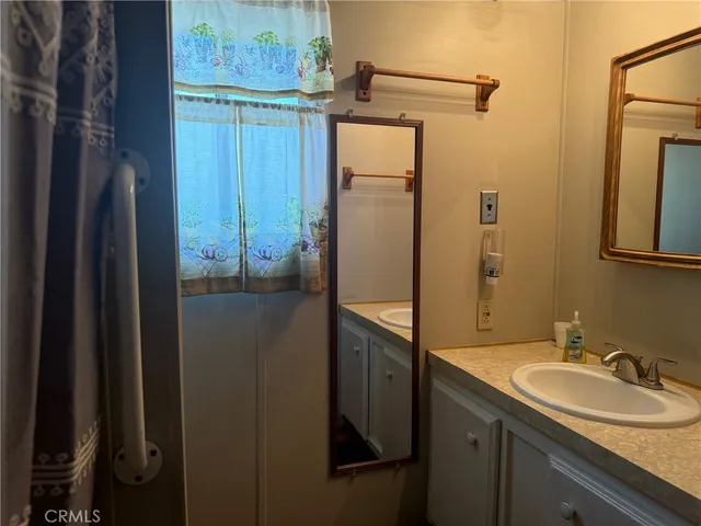 a bathroom with a sink and mirror