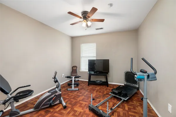 a work room with furniture and flat screen tv