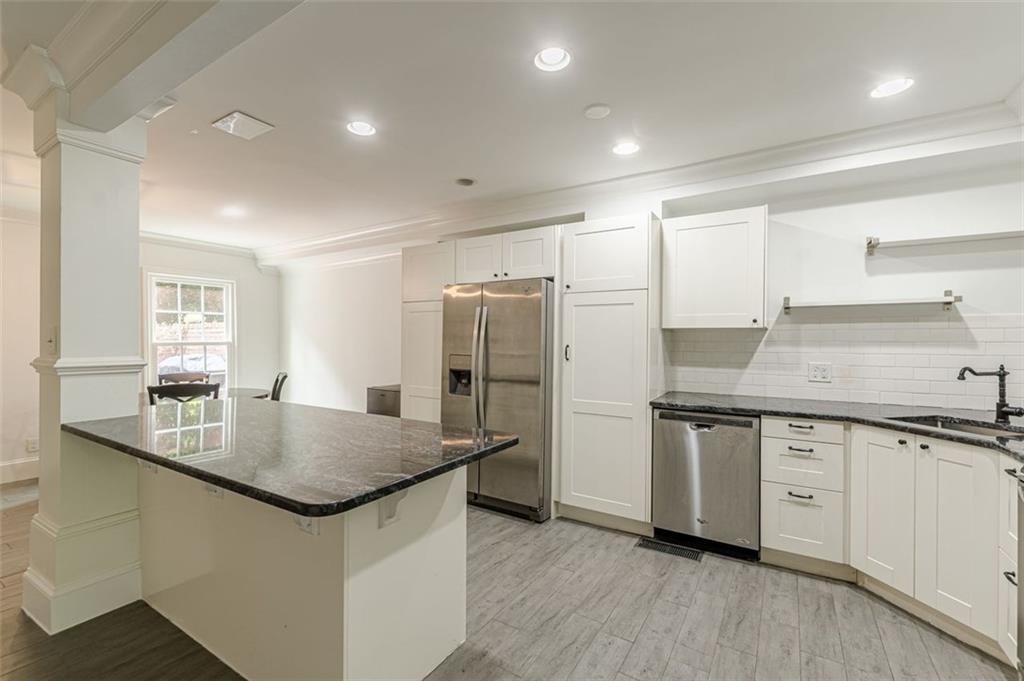 320 Alberta Terrace Northeast, Unit 3 Atlanta, GA 30305 - Photo 21 of 54 a kitchen with stainless steel appliances granite countertop a sink stove and refrigerator