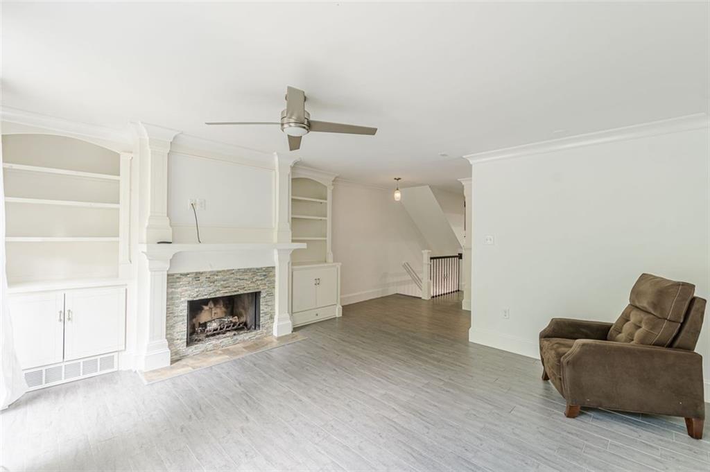320 Alberta Terrace Northeast, Unit 3 Atlanta, GA 30305 - Photo 26 of 54 a view of empty room with wooden floor and fireplace