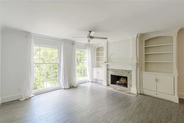 a bathroom with a granite countertop toilet and a sink
