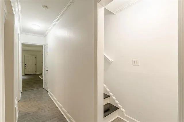 a view of a room with wooden floor and white walls