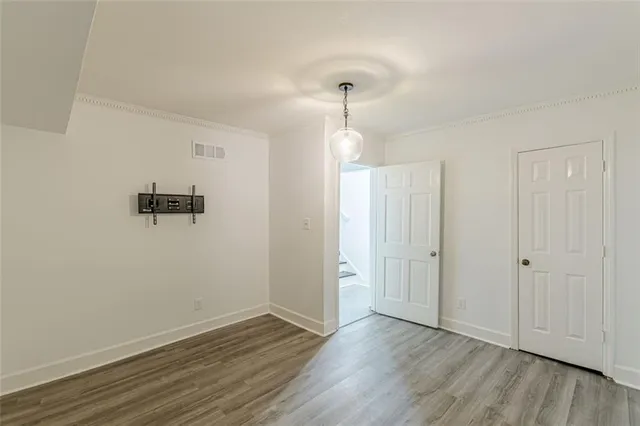 a view of a room with wooden floor