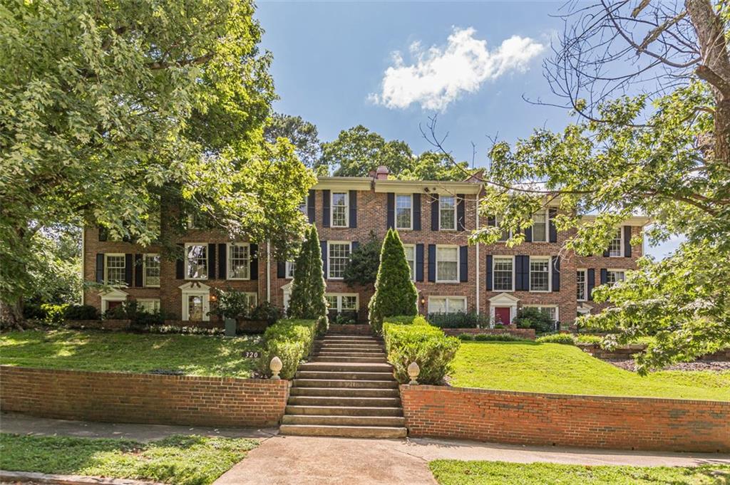 320 Alberta Terrace Northeast, Unit 3 Atlanta, GA 30305 - Photo 4 of 54 a front view of a house with garden and trees