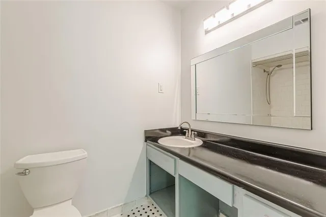 an empty room with windows and closet