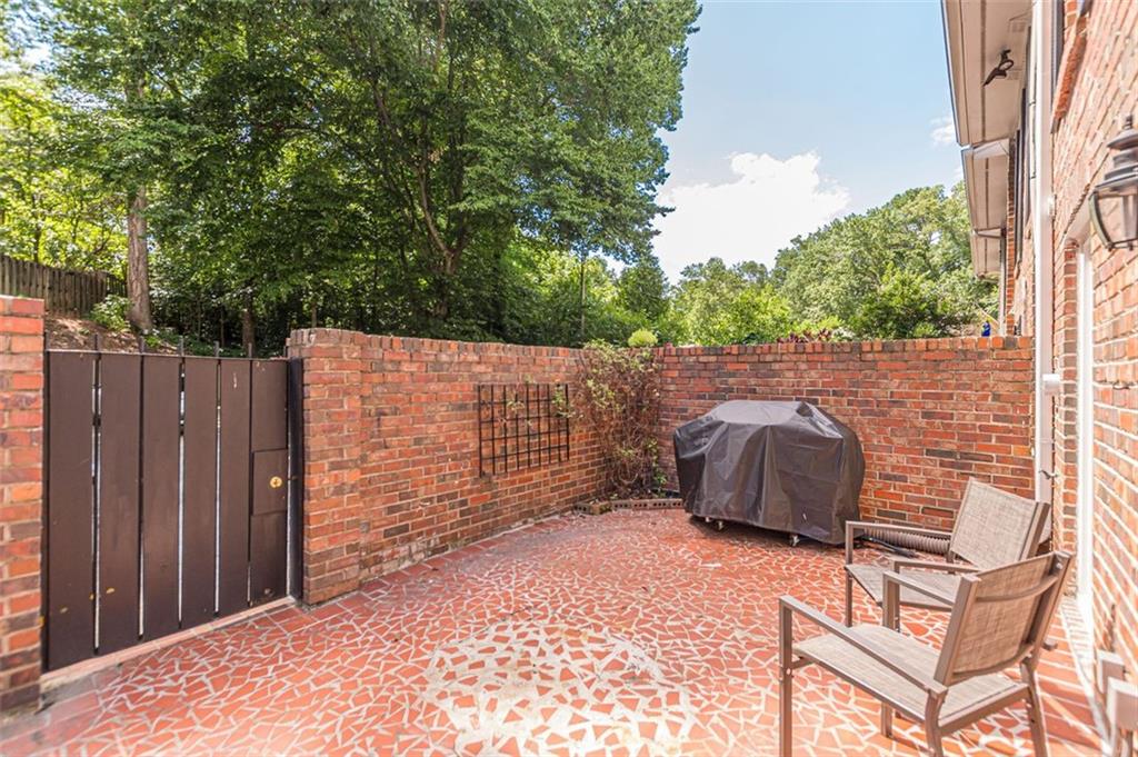 320 Alberta Terrace Northeast, Unit 3 Atlanta, GA 30305 - Photo 6 of 54 a backyard of a house with table and chairs