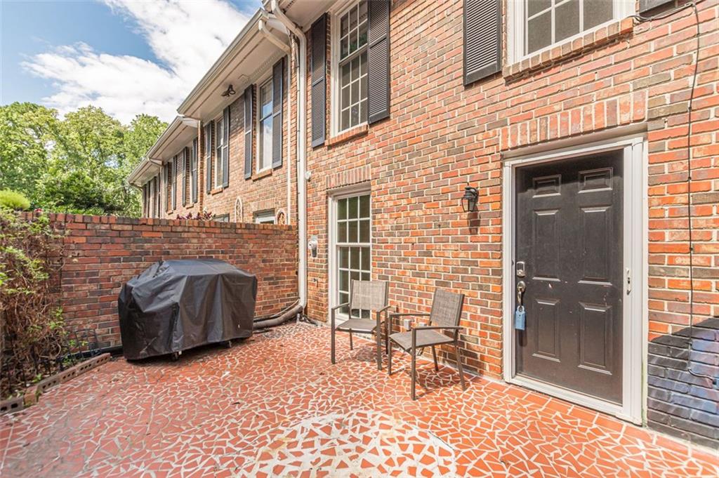 320 Alberta Terrace Northeast, Unit 3 Atlanta, GA 30305 - Photo 7 of 54 a brick building with a bench in front of it