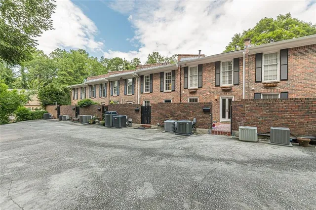 a view of a house with a yard and sitting area