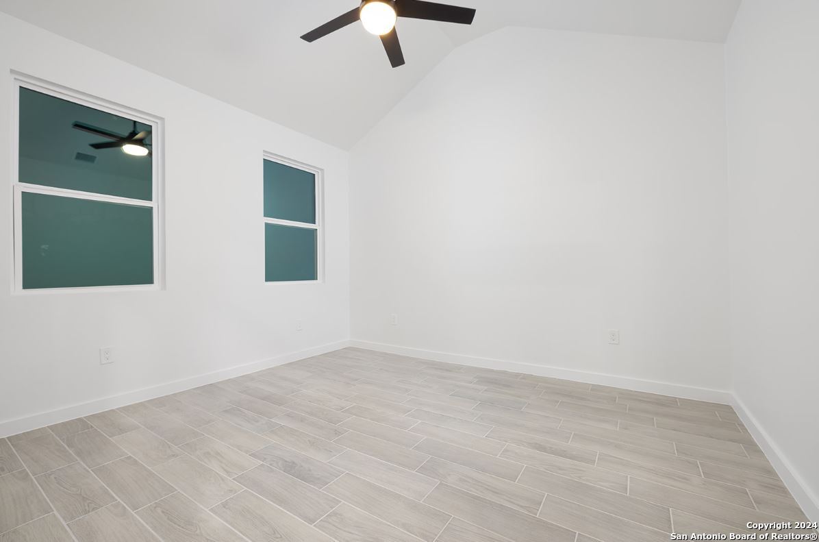 329 Blue Bonnet Breeze Spring Branch, TX 78070 - Photo 15 of 20 an empty room with a window and a chandelier fan