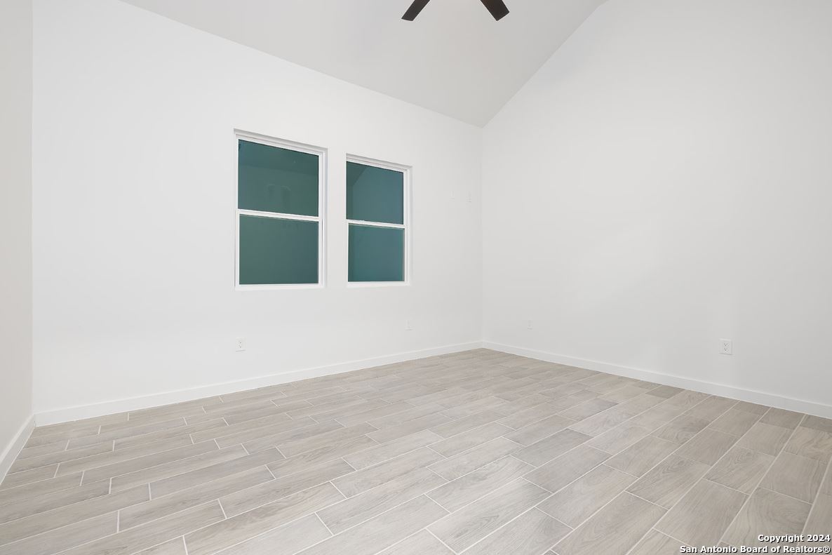 329 Blue Bonnet Breeze Spring Branch, TX 78070 - Photo 17 of 20 a view of an empty room with wooden floor and windows
