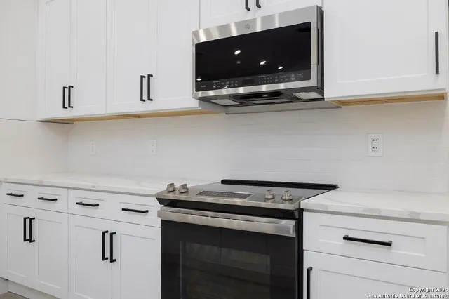 a stove top oven sitting inside of a kitchen