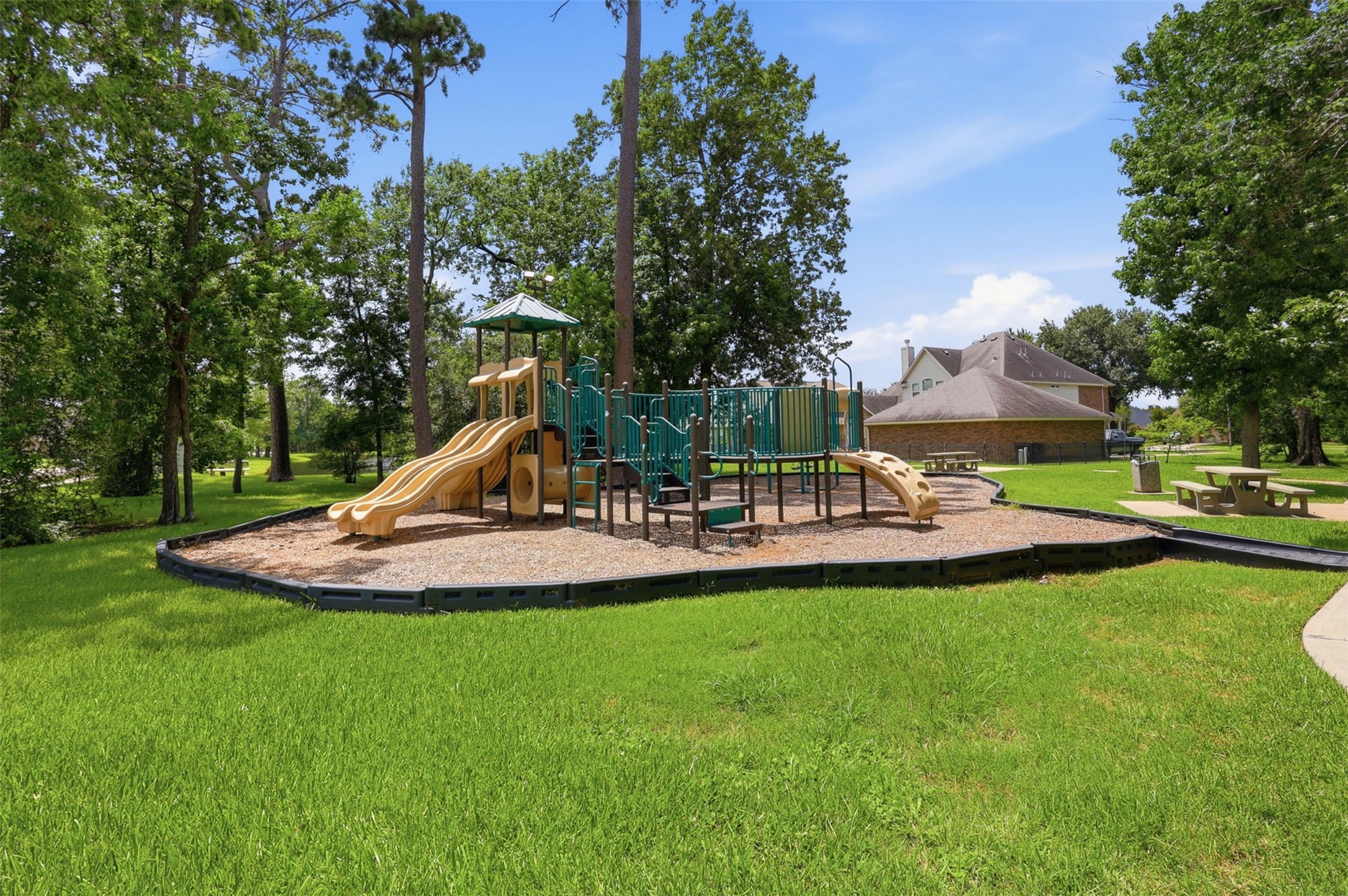 25926 Morgan Springs Spring, TX 77373 - Photo 48 of 49 Come home to the beauty of mature trees in this wonderful gated community! Residents enjoy playgrounds for the little ones, picnic areas with tables for family gatherings, beautifully landscaped green spaces, and so much more. It's the perfect place to relax, play, and create lasting memories.