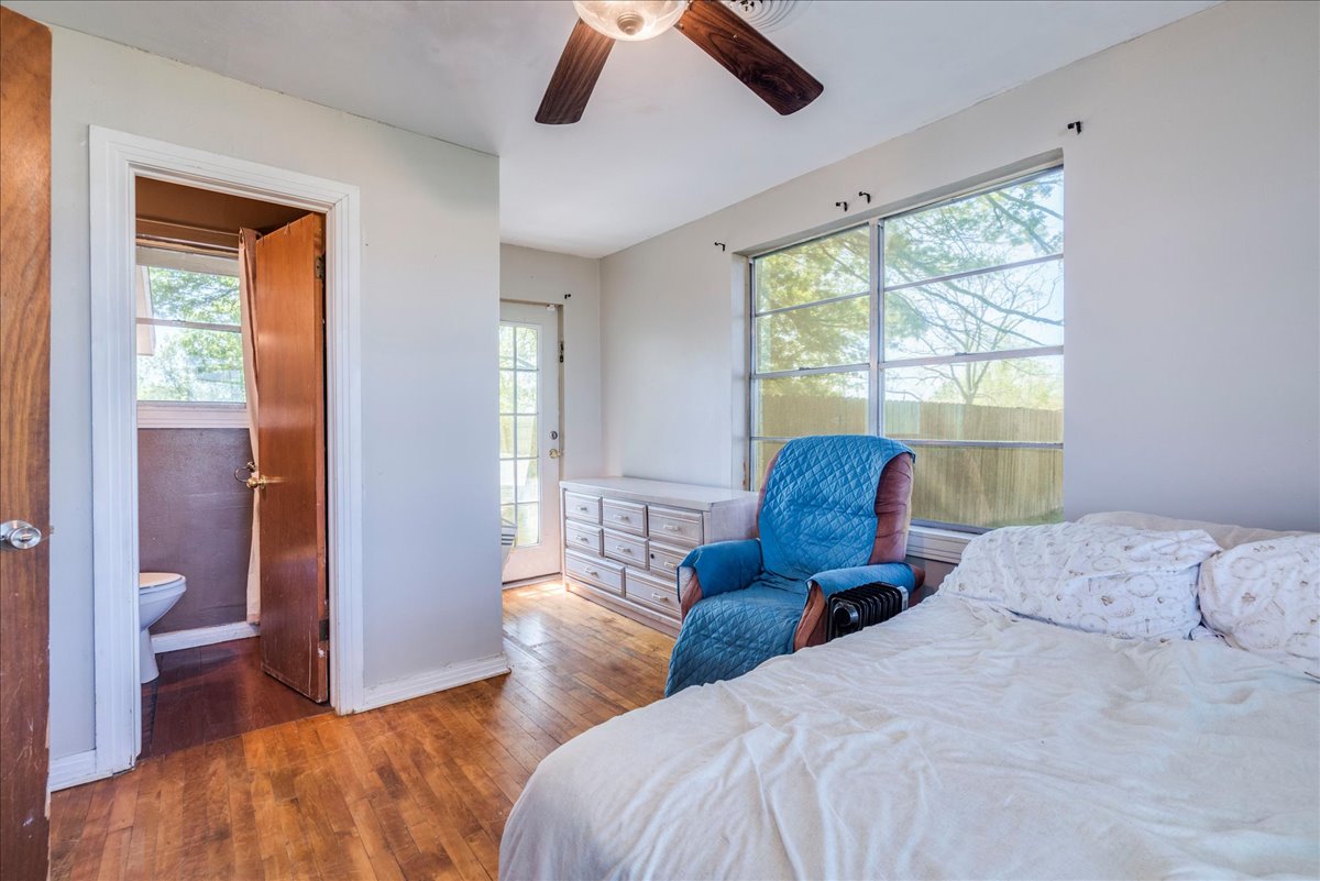 500 Blackjack Street Lockhart, TX 78644 - Photo 14 of 27 Bedroom featuring hardwood / wood-style floors and a ceiling fan