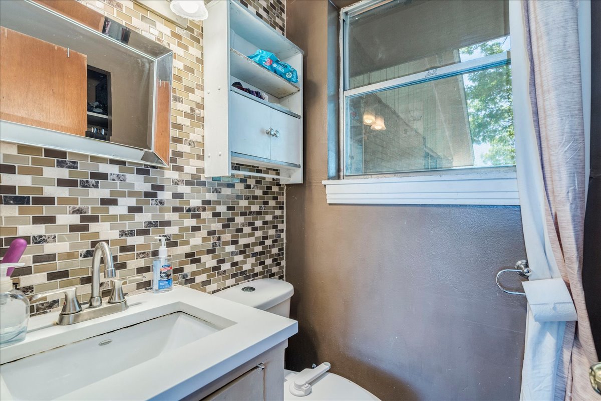 500 Blackjack Street Lockhart, TX 78644 - Photo 15 of 27 Half bath featuring vanity and tasteful backsplash