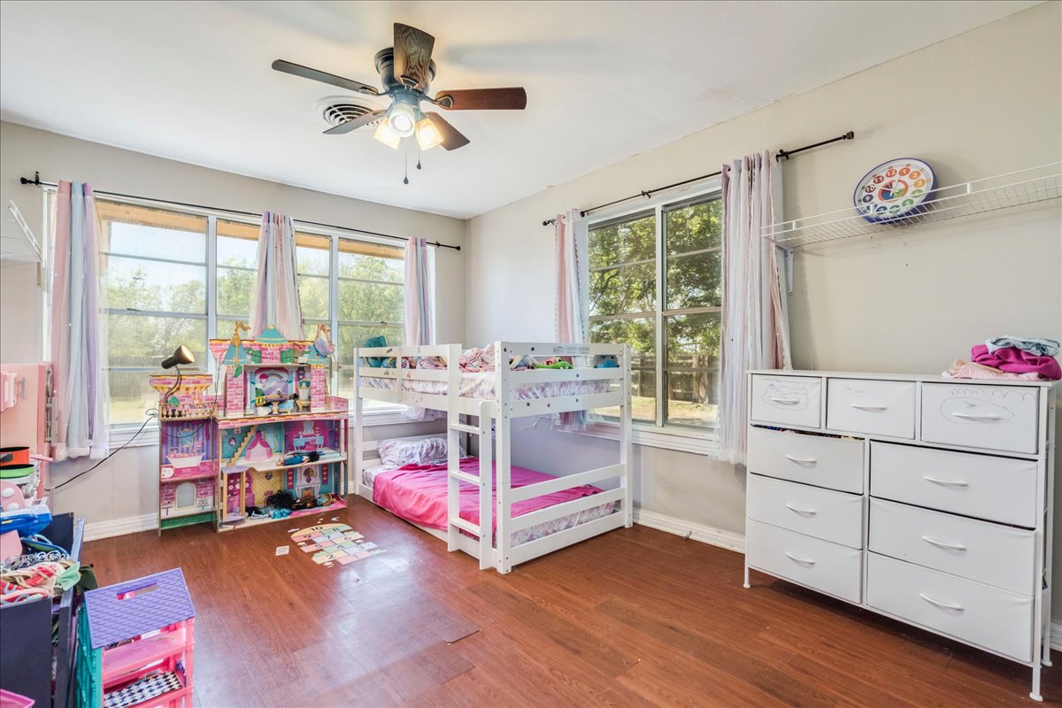 500 Blackjack Street Lockhart, TX 78644 - Photo 17 of 27 Bedroom featuring a ceiling fan and dark wood-style floors