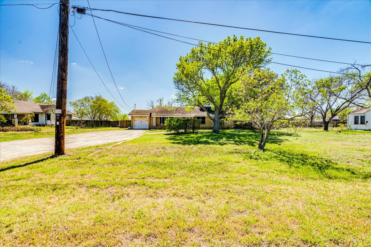 500 Blackjack Street Lockhart, TX 78644 - Photo 2 of 27 View of front of home with driveway, a garage, and a front lawn