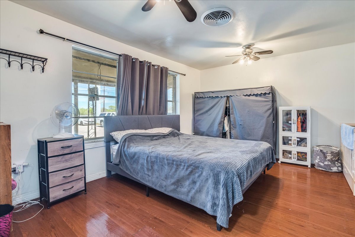 500 Blackjack Street Lockhart, TX 78644 - Photo 20 of 27 Bedroom with a ceiling fan and wood finished floors