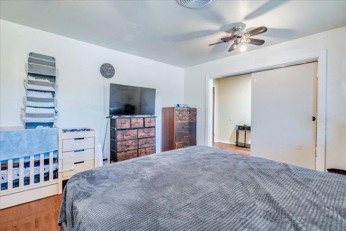 500 Blackjack Street Lockhart, TX 78644 - Photo 21 of 27 Bedroom with light wood-style flooring and a ceiling fan