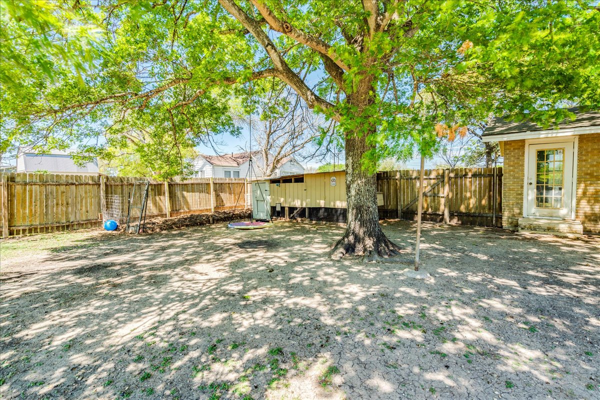 500 Blackjack Street Lockhart, TX 78644 - Photo 26 of 27 Fenced backyard with an outdoor structure