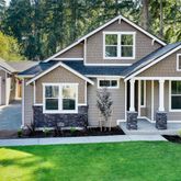 a front view of a house with a yard and porch