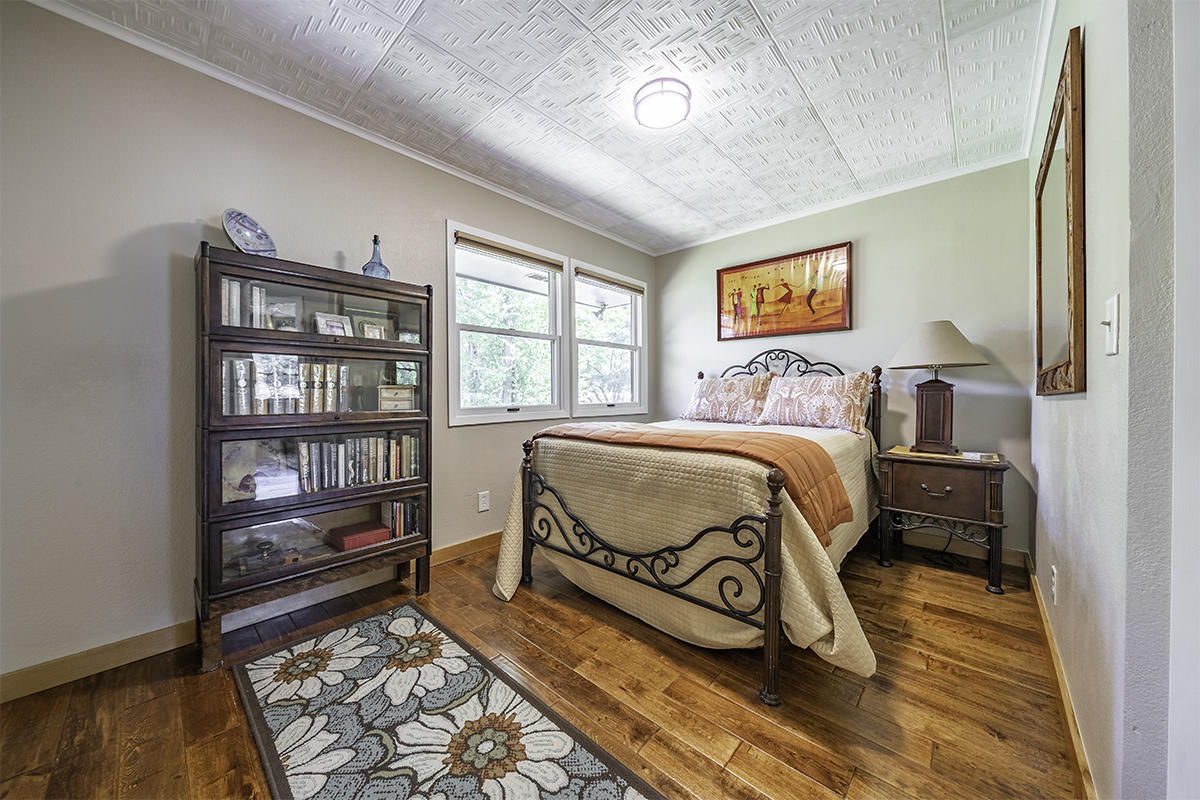 7785 Old Stage Road Central Point, OR 97502 - Photo 22 of 47 a bedroom with a bed and a book shelf