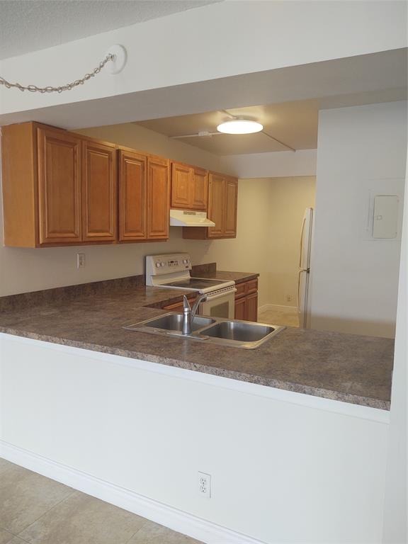 9 Royal Palm Way, Unit 201 Boca Raton, FL 33432 - Photo 2 of 21 a kitchen with stainless steel appliances granite countertop a sink a stove and a refrigerator