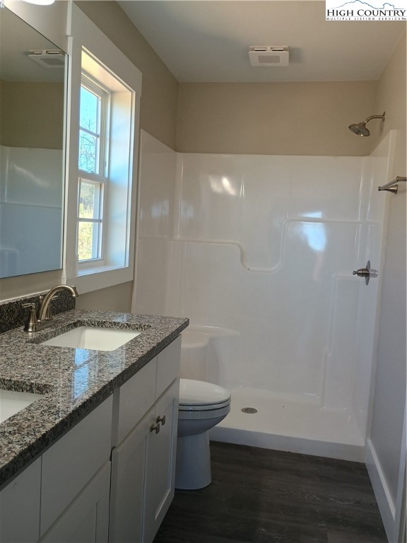 130 Millards Way Sparta, NC 28675 - Photo 3 of 12 a bathroom with a granite countertop sink toilet and shower
