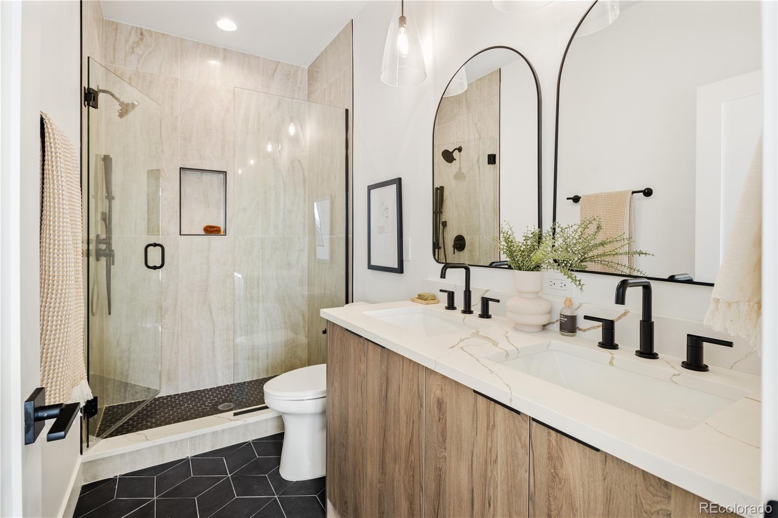 4435 Tennyson Street Denver, CO 80212 - Photo 16 of 30 a bathroom with a double vanity sink toilet and shower