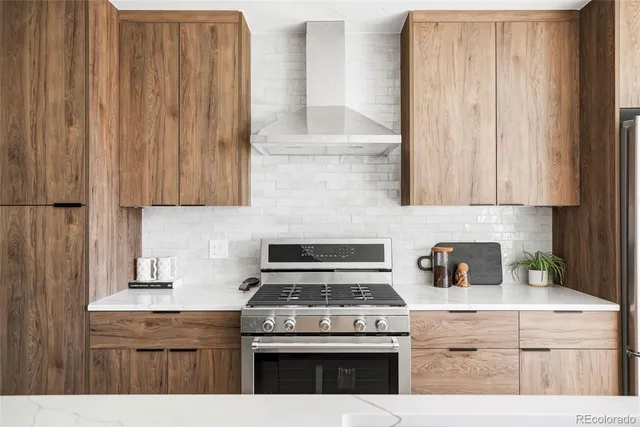 a kitchen with stainless steel appliances a sink stove and cabinets