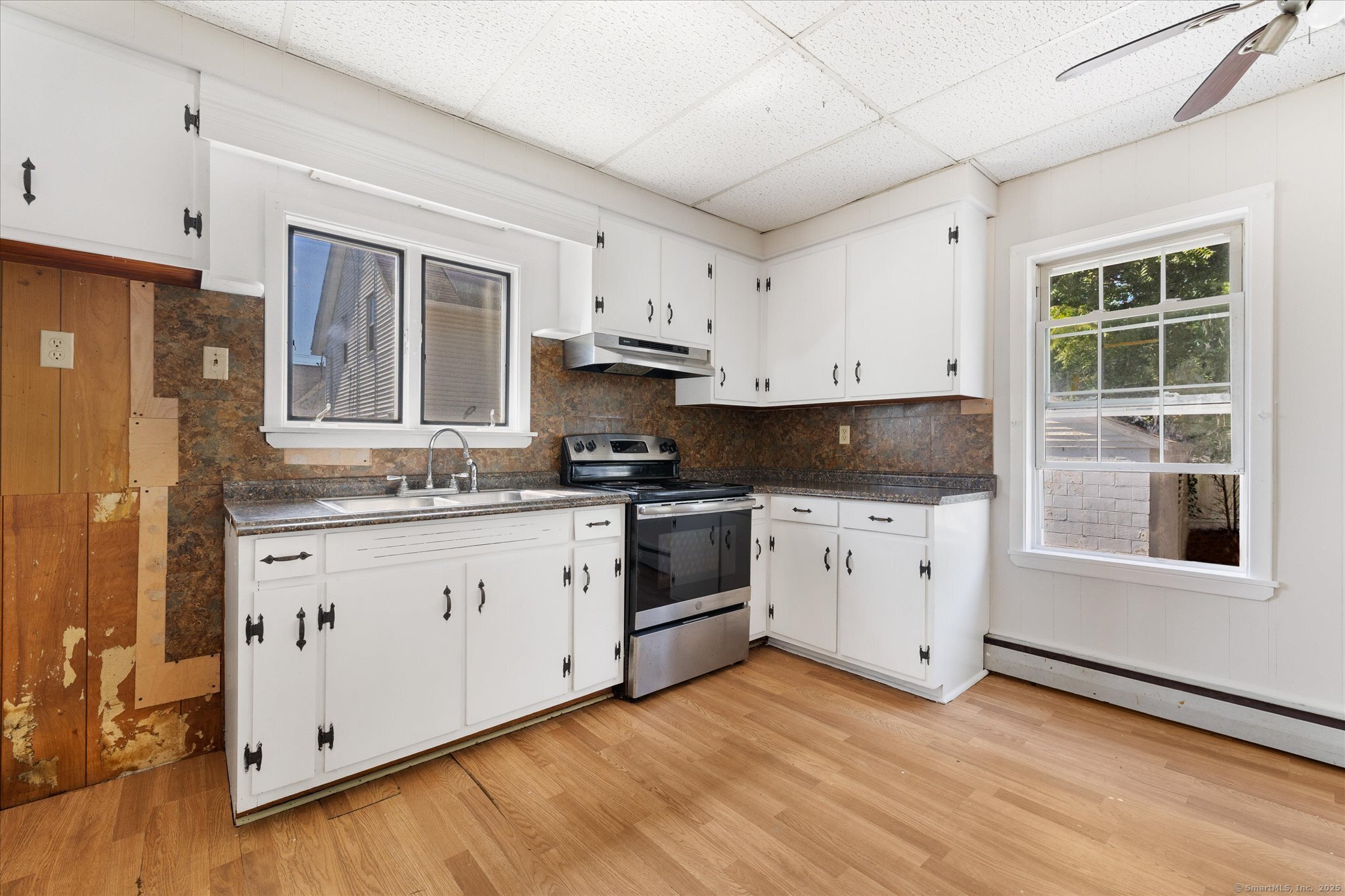 42-44 Church Street Plainfield, CT 06354 - Photo 11 of 36 a kitchen with granite countertop white cabinets and black stainless steel appliances