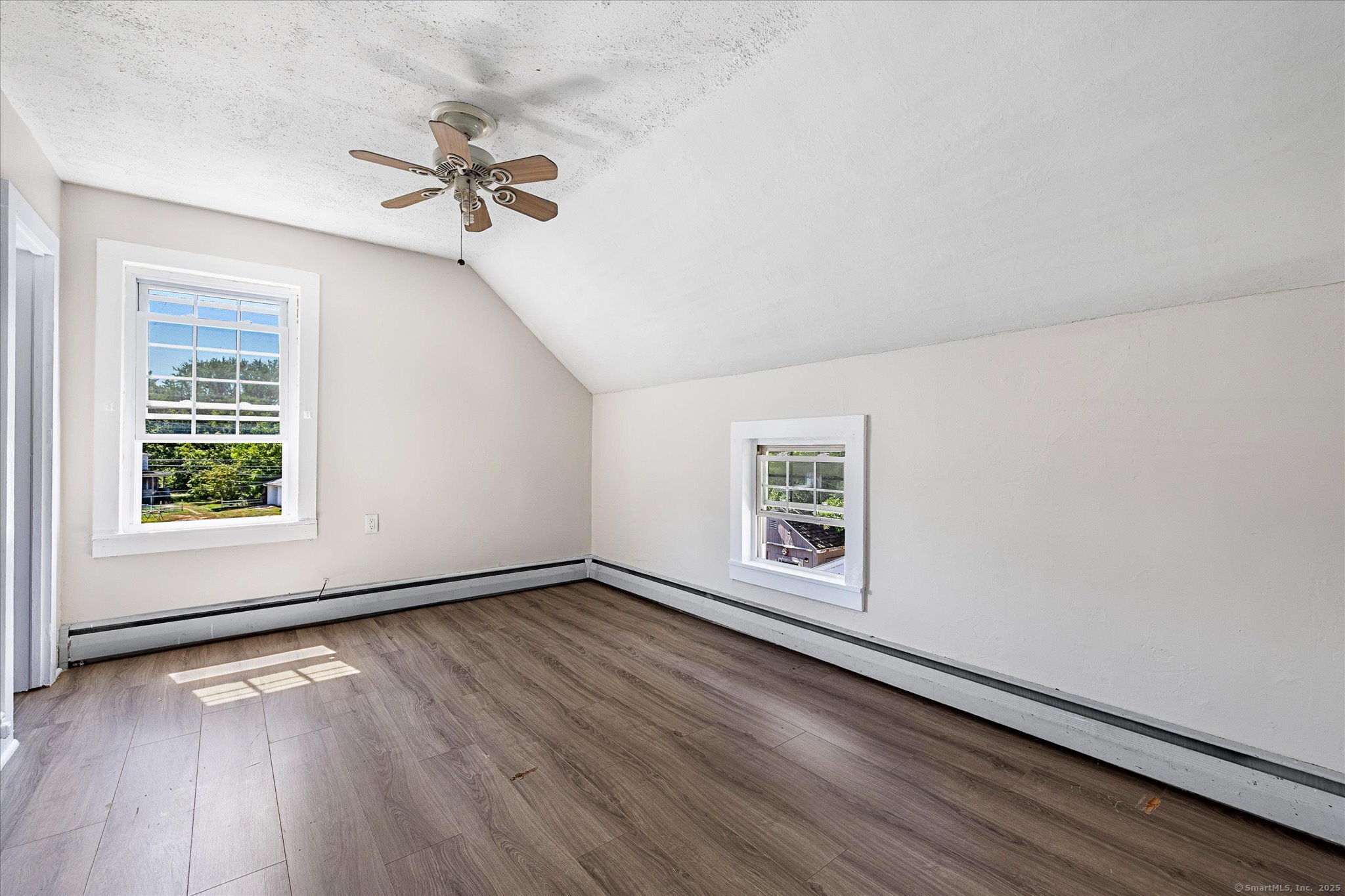 42-44 Church Street Plainfield, CT 06354 - Photo 19 of 36 an empty room with wooden floor chandelier fan and windows