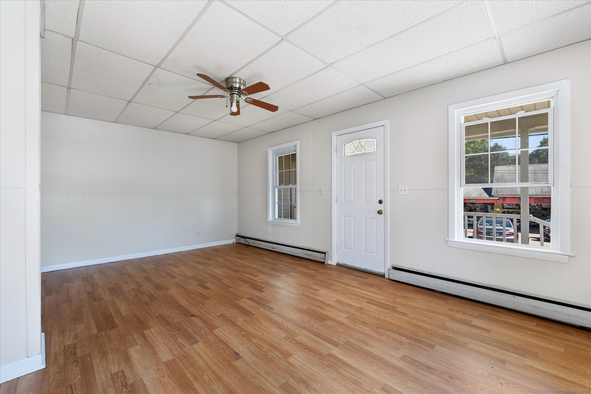 42-44 Church Street Plainfield, CT 06354 - Photo 7 of 36 a view of an empty room with wooden floor and a window