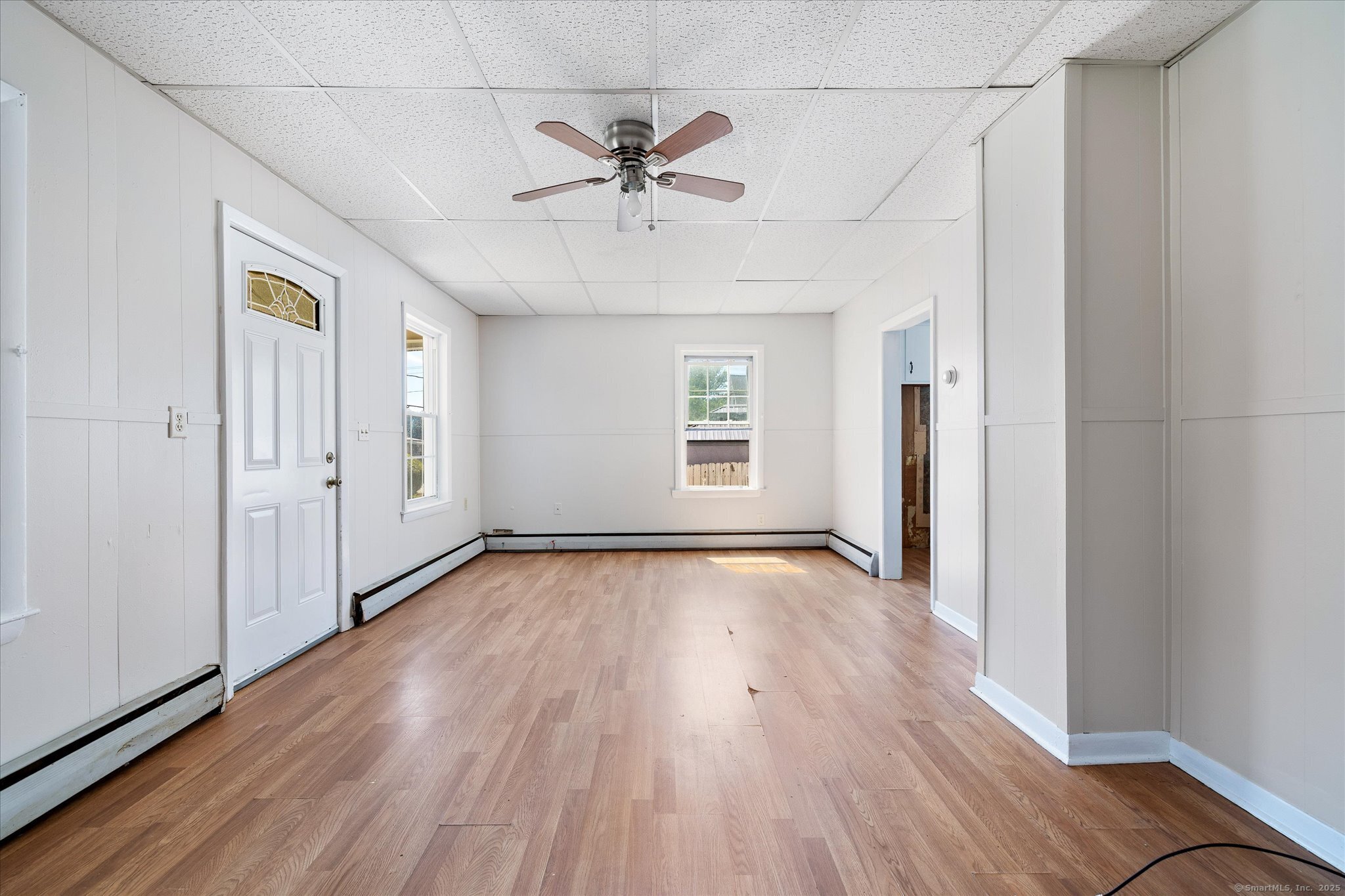42-44 Church Street Plainfield, CT 06354 - Photo 9 of 36 an empty room with wooden floor chandelier fan and windows
