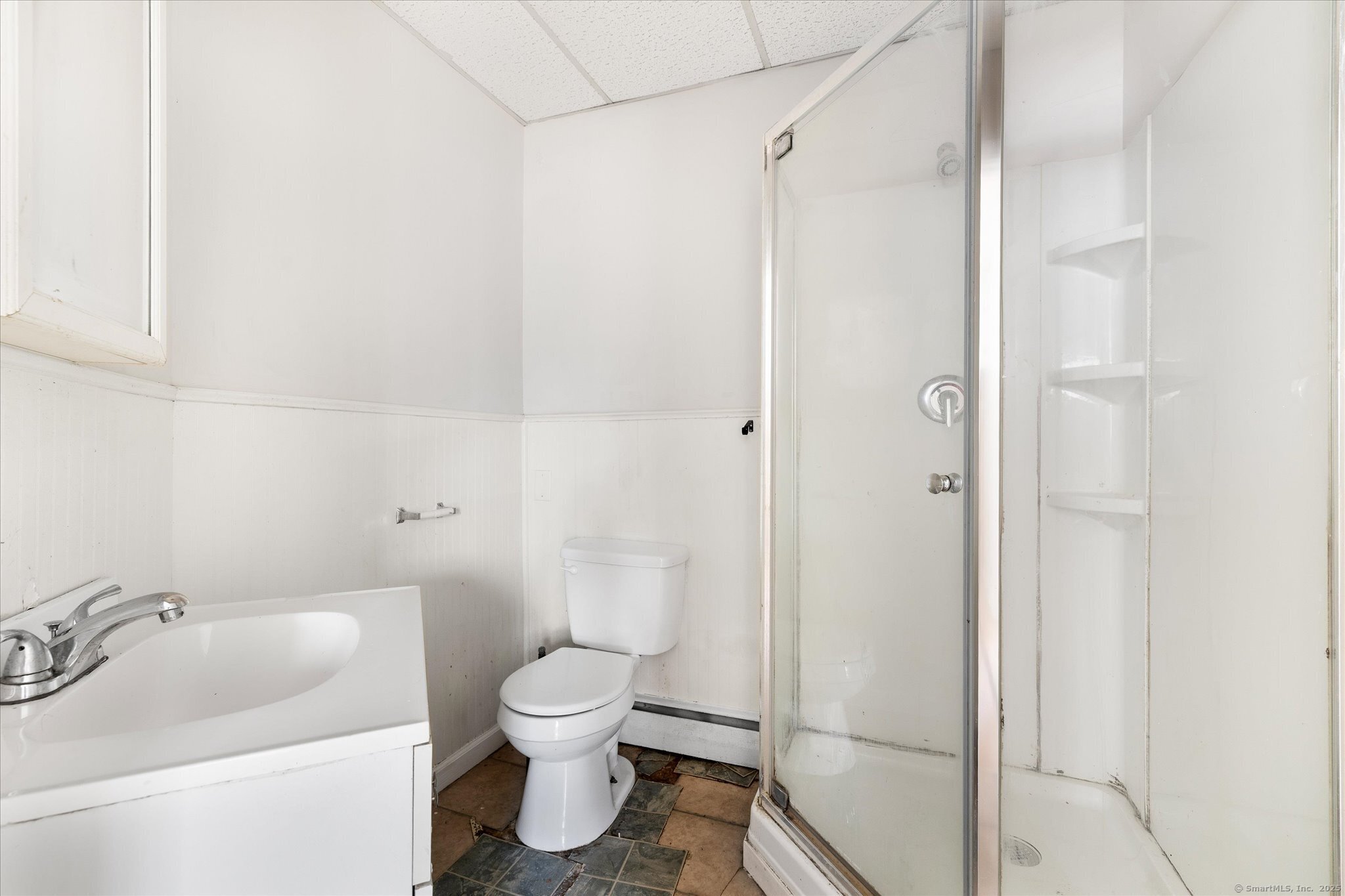 42-44 Church Street Plainfield, CT 06354 - Photo 10 of 36 a white toilet sitting next to a bathroom sink