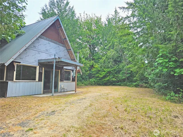a view of house with backyard and garden
