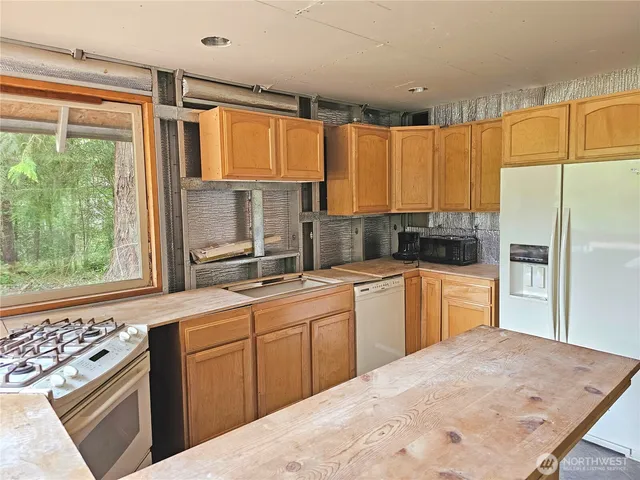 a kitchen with a sink stove and refrigerator
