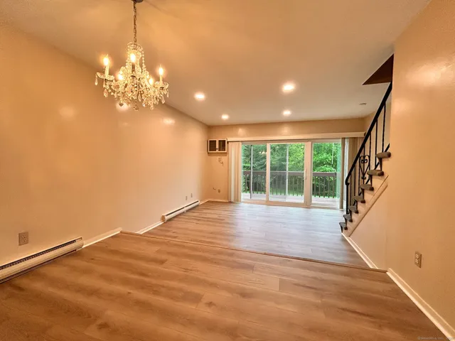 a view of a room with wooden floor and large windows