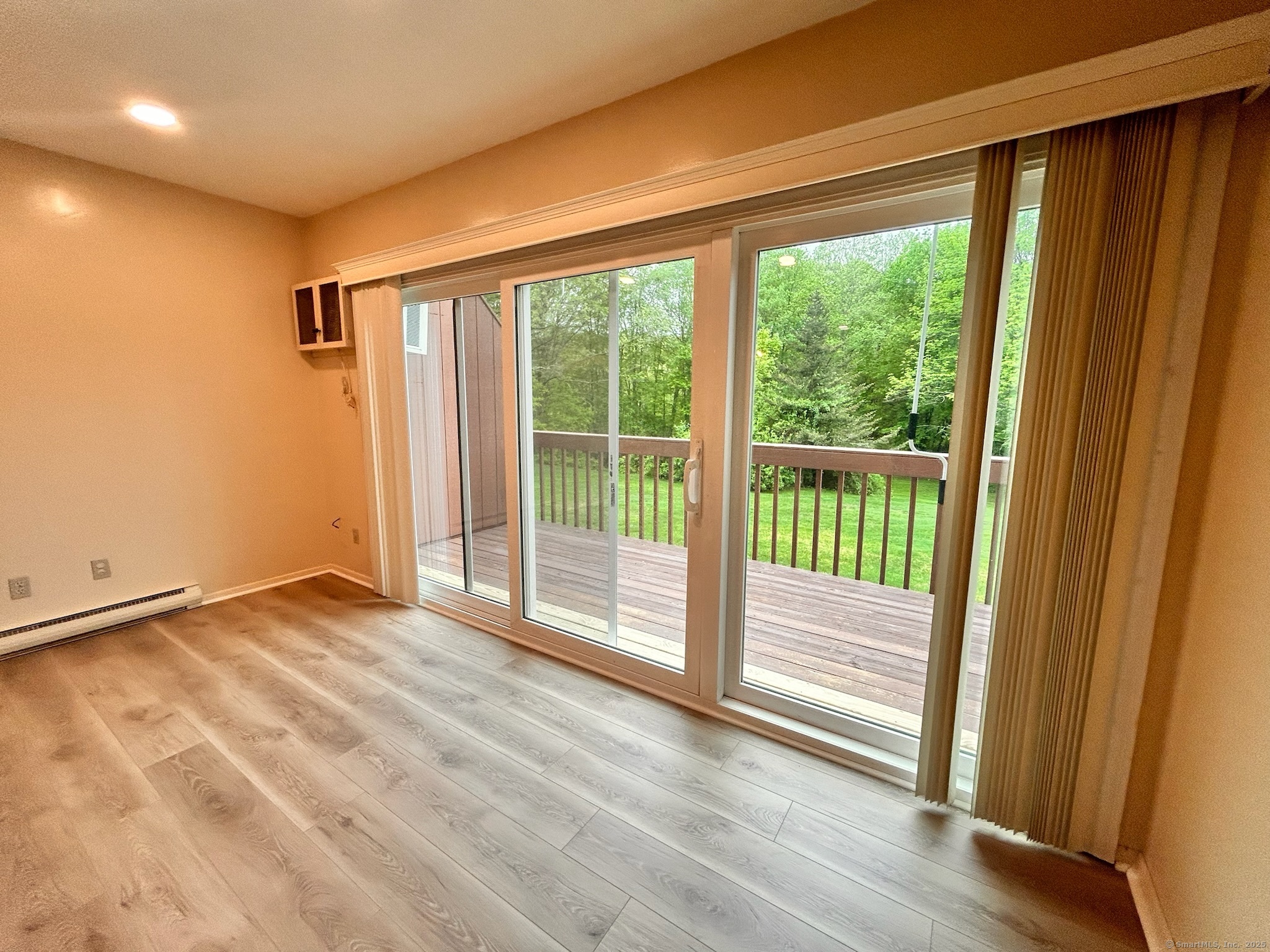 213 Baxter Road, Unit B Storrs Mansfield, CT 06268 - Photo 2 of 12 a view of an empty room and wooden floor
