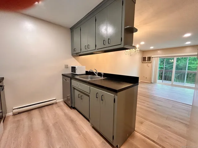 a kitchen with a sink a stove and cabinets